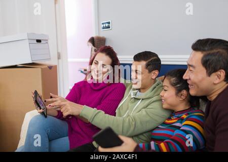 Friends taking a break from moving, using digital tablet Stock Photo