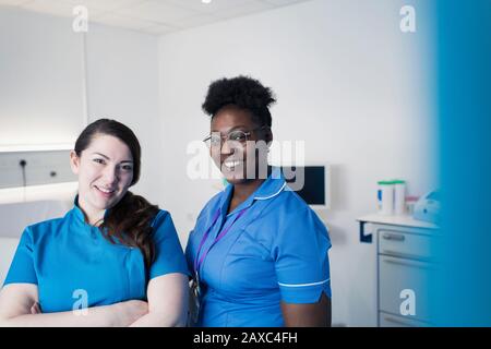 Portrait confident female nurses in hospital room Stock Photo