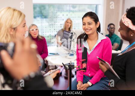 Community college students at microphone in journalism class Stock Photo