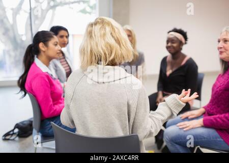 Womens support group talking in circle Stock Photo