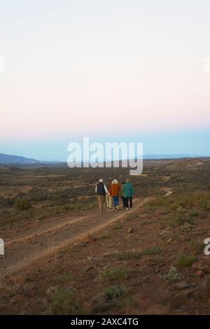 Safari tour group walking along dirt road on remote wildlife reserve Stock Photo