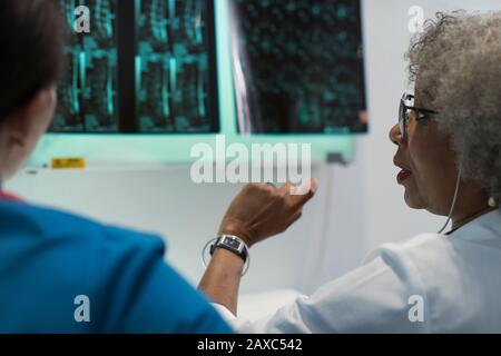 Female doctors discussing x-rays in hospital Stock Photo
