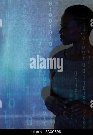 Silhouette of businesswoman against binary code on projection screen Stock Photo