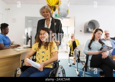Portrait smiling girl patient in wheelchair at clinic Stock Photo
