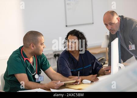 Doctor and nurses working at computer in clinic Stock Photo