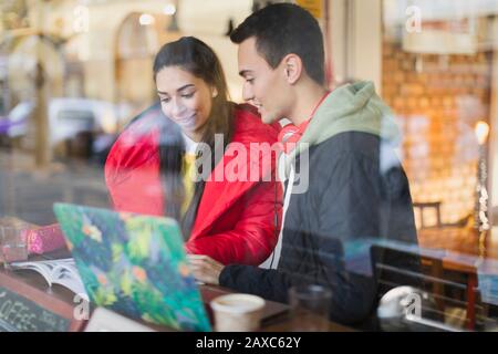 Young couple studying at cafe window Stock Photo