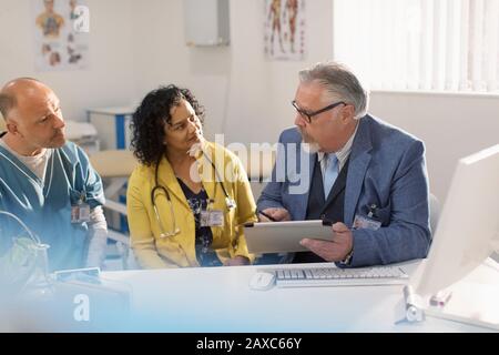 Doctors and administrator meeting in doctors office Stock Photo