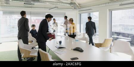 Business people leaving conference room meeting Stock Photo