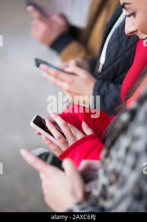 Young adults using smart phones Stock Photo