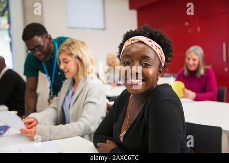Portrait confident young female community college student in classroom Stock Photo