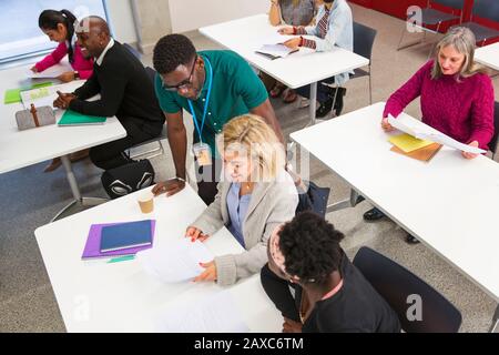 Community college teacher and students in classroom Stock Photo