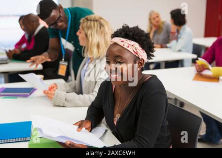 Smiling, confident young female community college student in classroom