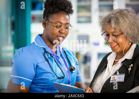 Female doctor and nurse talking Stock Photo