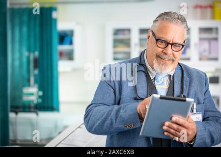 Male doctor using digital tablet in clinic Stock Photo