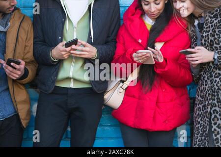Young adults using smart phones Stock Photo