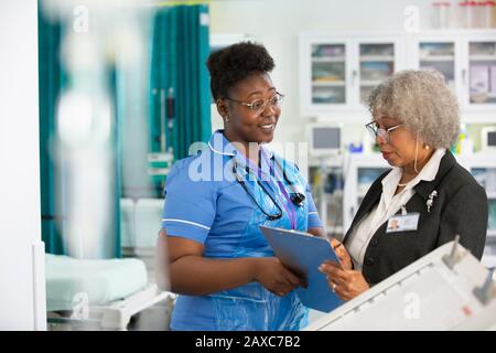 Female doctor and nurse making rounds in hospital Stock Photo