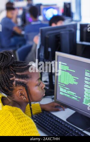 Focused junior high girl student using computer in computer lab Stock Photo