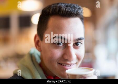 Close up portrait confident young man drinking coffee Stock Photo