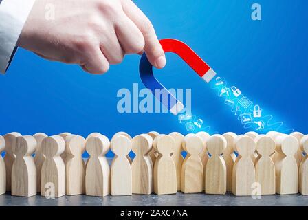 Hand with a magnet collects personal data from crowd figures online Internet users. Confidentiality protection of private information. Financial data Stock Photo