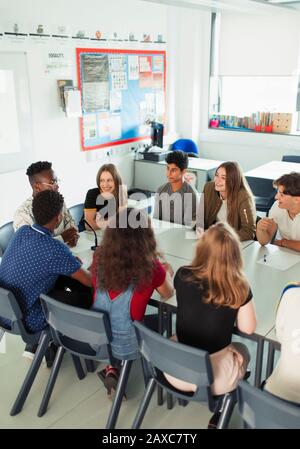 High school students talking during debate class in classroom Stock Photo