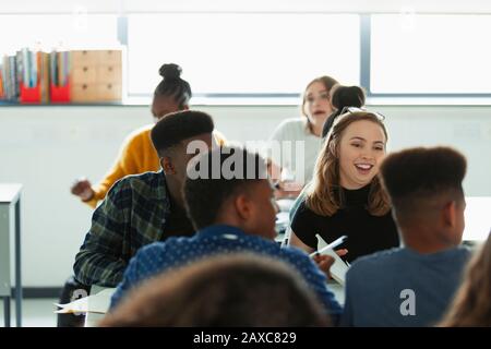 High school students talking in classroom Stock Photo