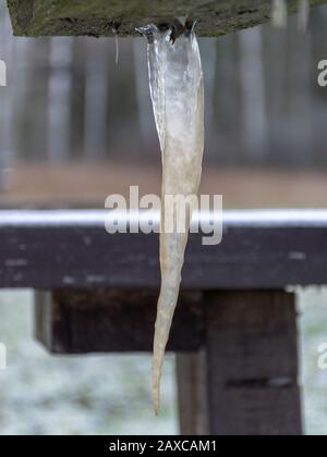 picture with icicle, icicle formed under a wooden table Stock Photo