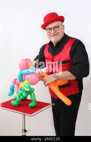 A children's entertainer doing tricks with balloons Stock Photo