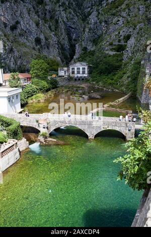 KOTOR, MONTENEGRO-CIRCA JUN, 2016: Stone bridge across moat passes to gate in the wall of Kotor fortress. The fortifications of Kotor are an integrate Stock Photo