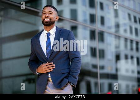Candid lifestyle photo of a handsome african american businessman in a suit, attractive, multiethnic, mixed ethnicity model Stock Photo