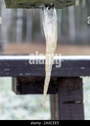 picture with icicle, icicle formed under a wooden table Stock Photo