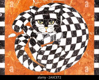 Cat from of black and white pieces of marble. Chess cat on an orange background. Stock Photo