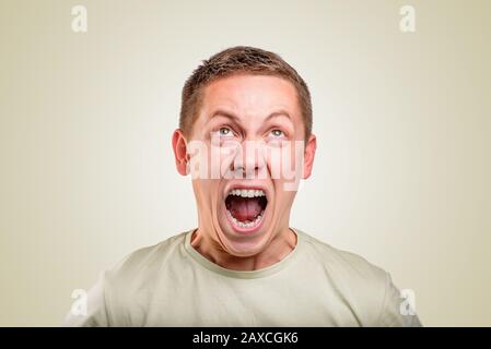 An angry young man screams. Stock Photo