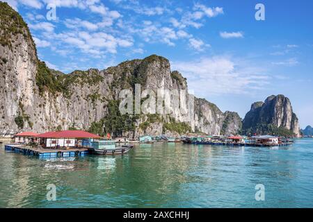 Floating village and limestone karsts in Halong Bay, North Vietnam. Stock Photo