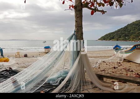 Fishing net spread out on the sand to dry. It's the end of the fishing season. Stock Photo