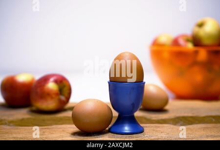 composition of eggs and apples on wood Stock Photo