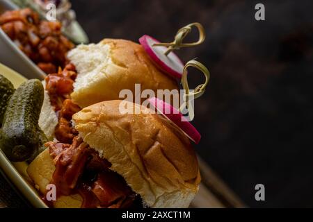 Vegan jack-fruit barbecue sliders with BBQ baked beans, oven baked sweet potato fries and coleslaw. Stock Photo