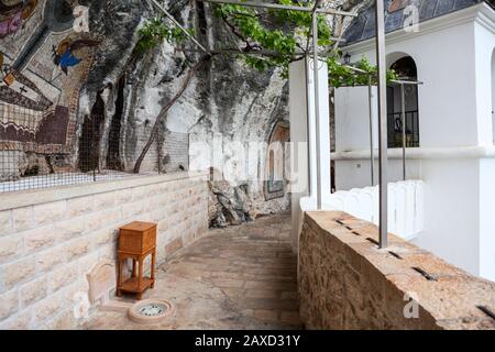 OSTROG, MONTENEGRO - CIRCA JUN, 2016: Way to Church of the Presentation in Ostrog monastery. Beautiful painting is on the wall. It is a monastery of t Stock Photo