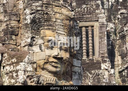 Human Face Mural Detail on Richly Decorated Bayon Khmer Temple at Angkor Wat Ruins, World Heritage Site near Siem Reap, Cambodia Stock Photo