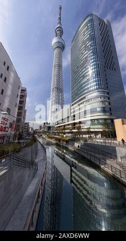 Outside Vertical Panoramic View of Famous Skytree Tower Building Exterior, World Tallest Tower and Second Tallest Structure. Sunny Day in Tokyo Japan Stock Photo