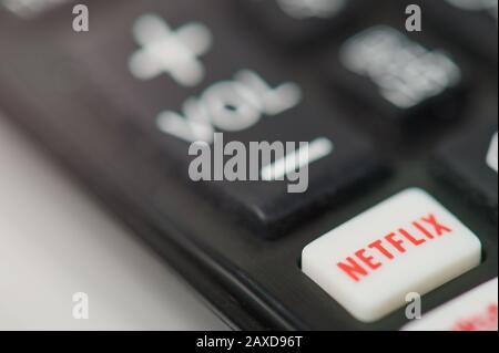 New-York , USA - February  11, 2020: Netflix button on tv remote macro close up view Stock Photo