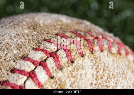Close up macro photograph of stitching on old worn baseball. Stock Photo