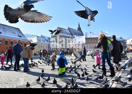 BRASOV, ROMANIA - February, 2020. Wonderful mood at Brasov Council Square ,amazing tourists attraction in Brasov city, Prahova Valley , Romania Stock Photo