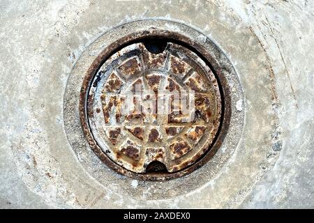 a rusty old water drain manhole cover Stock Photo