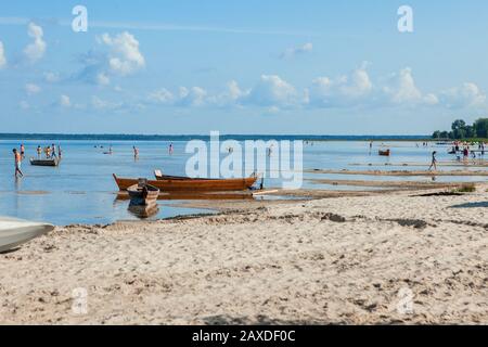 Old fisherman boat at sunrise time on the beach Stock Photo