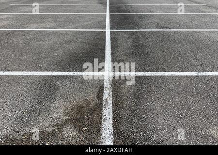 detailed view of parking spaces and lines on asphalt and  oil stained Stock Photo