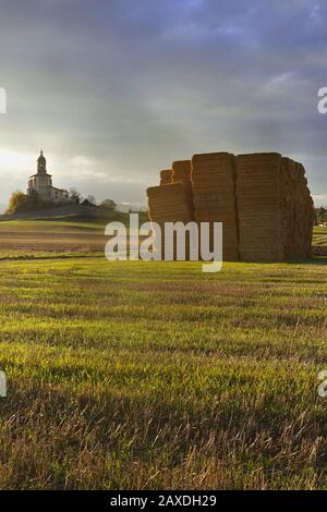 A freshly cut fiean old Church stood alone on a hill in the sunlight Stock Photo