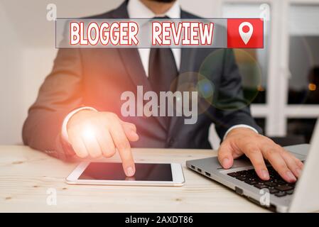 Text sign showing Blogger Review. Business photo showcasing making a critical reconsideration and summary of a blog Male human wear formal clothes pre Stock Photo