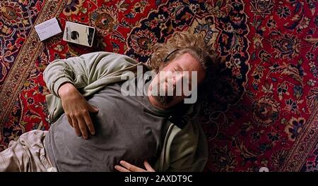 The Big Lebowski (1998) directed by Joel and Ethan Coen and starring Jeff Bridges as Jeffrey 'The Dude' Lebowski shown relaxing on his new rug. Stock Photo