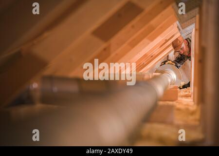 House Air Ventilation and Cleaning System Checking. Professional Installer Replacing Air Filter. on the Attic. Stock Photo