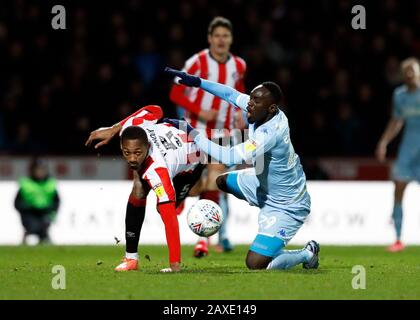 Griffin Park, London, UK. 11th Feb, 2020. English Championship Football, Brentford FC versus Leeds United; Ethan Pinnock of Brentford challenges Jean-Kevin Augustin of Leeds United Credit: Action Plus Sports/Alamy Live News Stock Photo